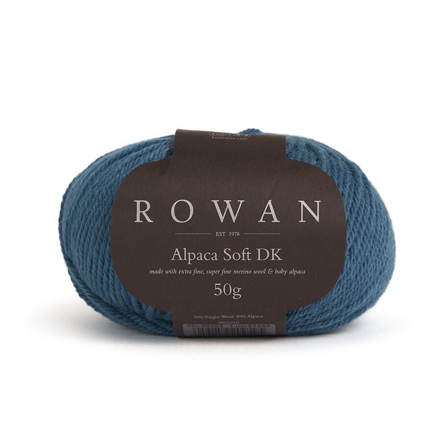 Blue skein of yarn with a Rowan label on a white background