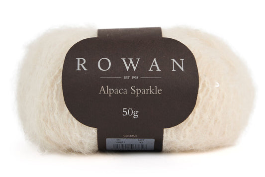 Cream color Ball of yarn with white sequins with Rowan label on a white background